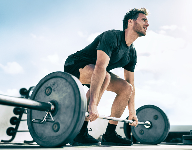 A photo of a man lifting the barbell.