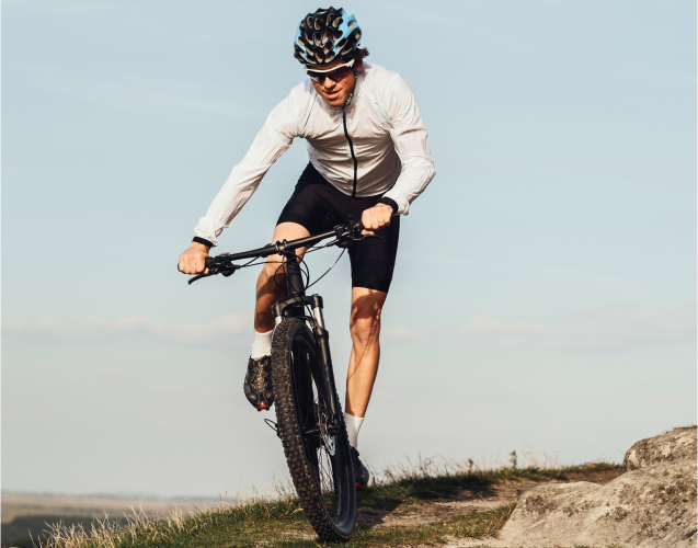 A photo of a man riding a bicycle.