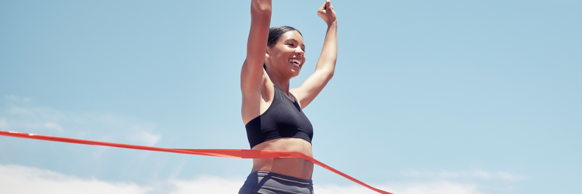 A photo of a woman crossing the finish line.