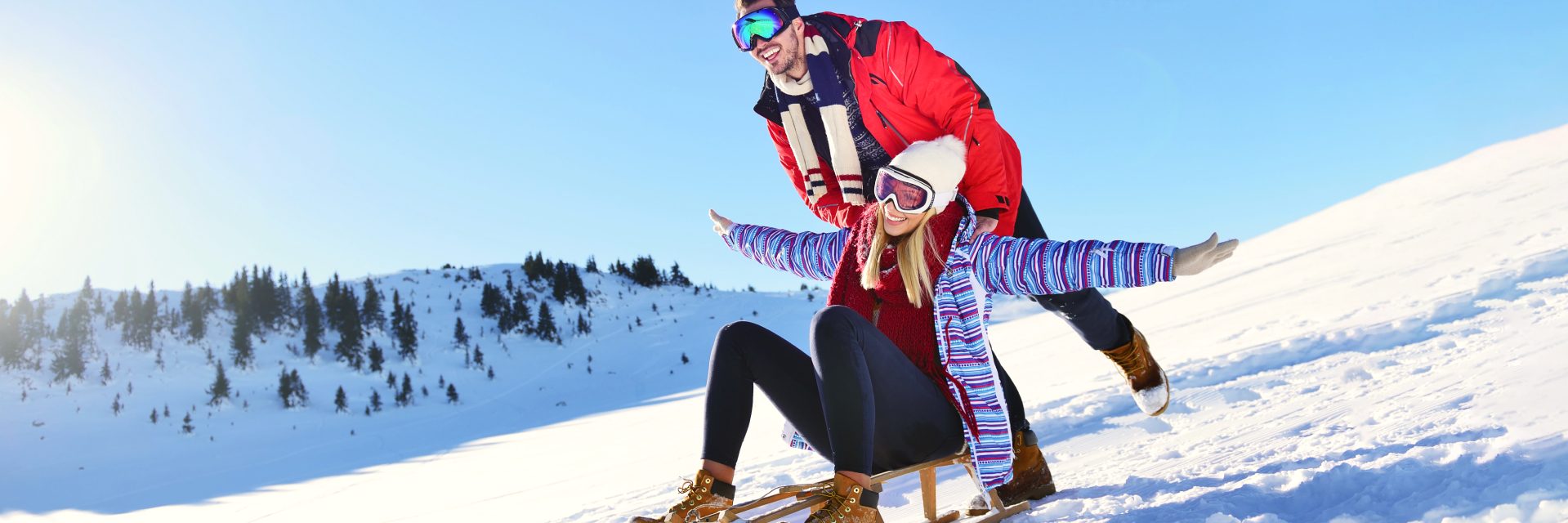 A photo of two people standing on a snow.