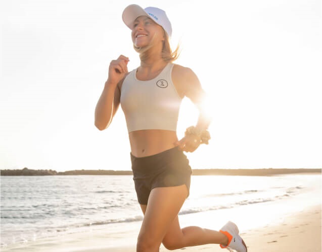 A woman is running bearby the sea